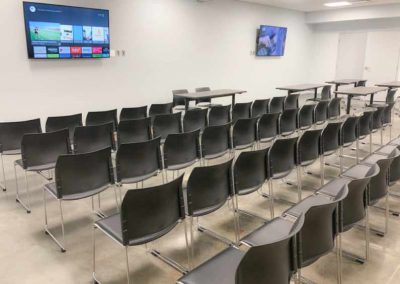 Indoor community room with chairs and tv's