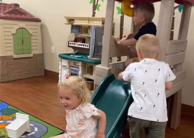 Kids playing inside of daycare center.