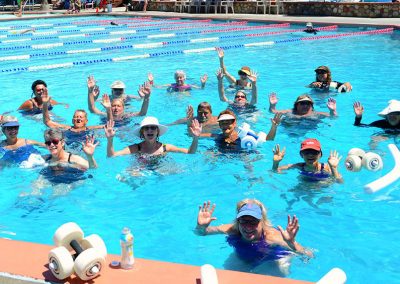 group fitness class in the lap pool with weights and pool noodles