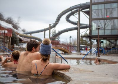 young couple enjoying watching other people swim and ride down the slides