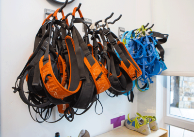 climbing harnesses hang in the climbing wall