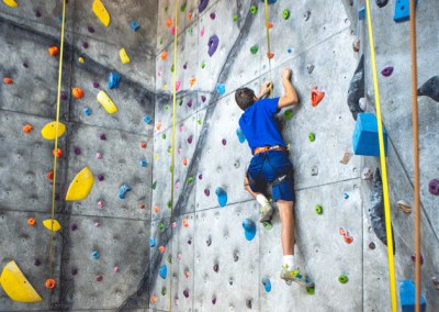 Young boy climbs the climbing wall at Old Town Hot Springs