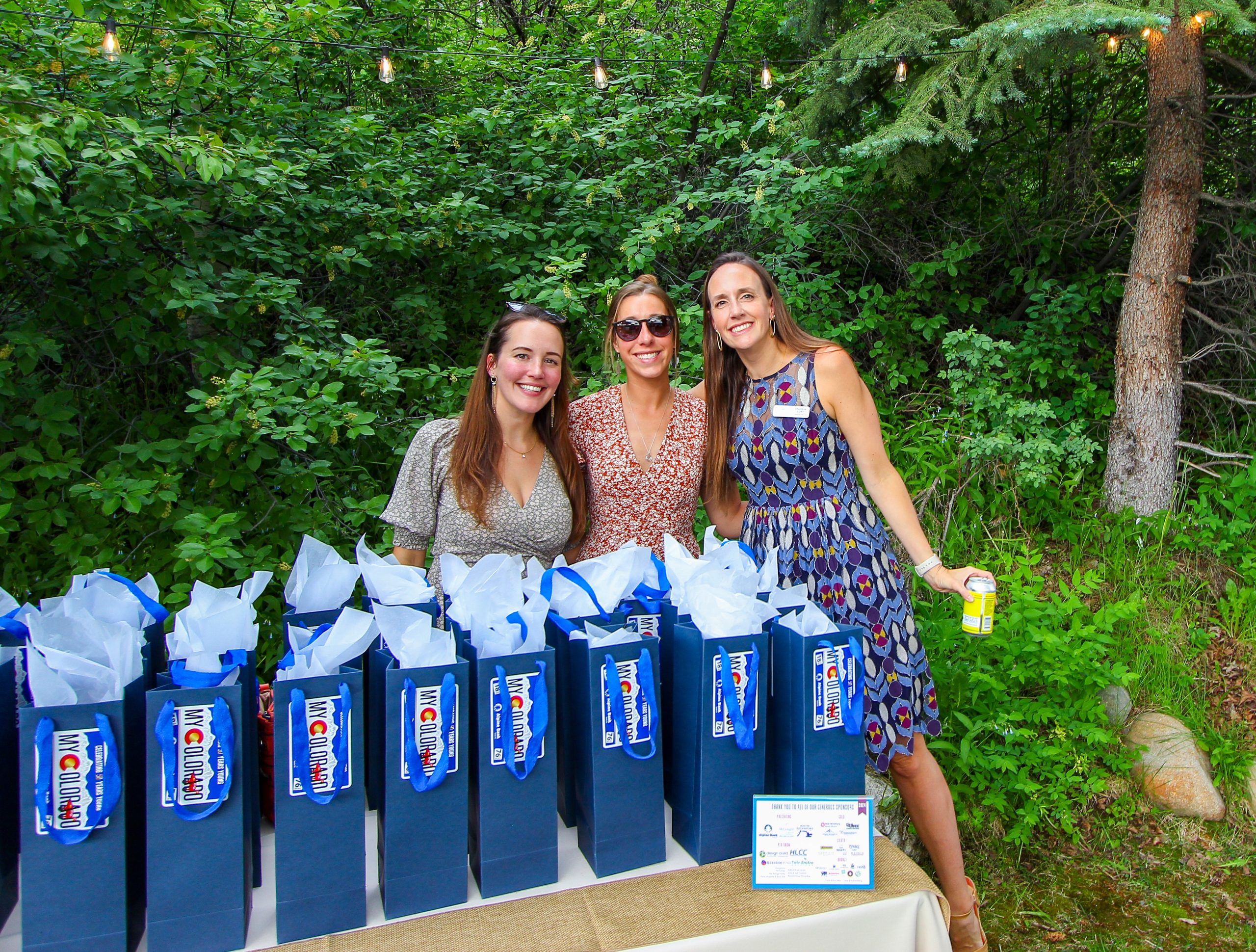 Old Town Hot Springs employees selling wine sponored by Alpine Bank at the Flip Flop Fete