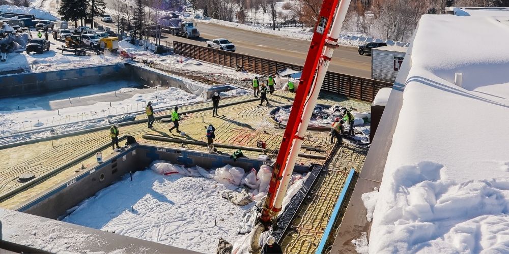 Capital Campaign Construction crew fill pool with concrete in winter
