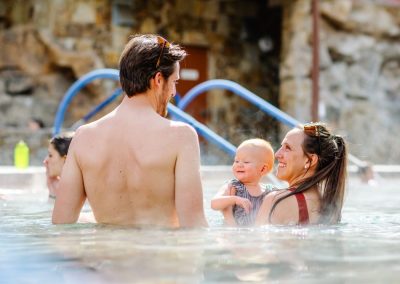 A young family enjoys a dip in the hot pool at Old Town Hot Springs.