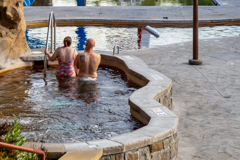 spa three A couple exits spa three, a natural hot springs pool filled with warm water.