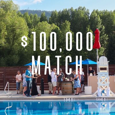 chamberlin birch, a women and man band walk and smile in the snow covered streets of steamboat springs