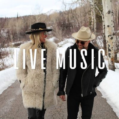 chamberlin birch, a women and man band walk and smile in the snow covered streets of steamboat springs